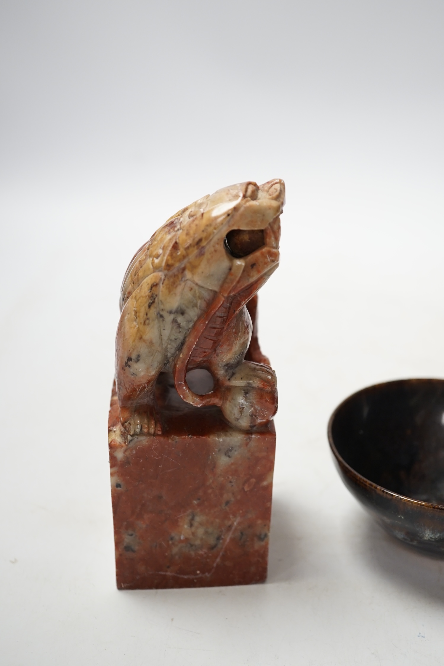 A large Chinese carved soapstone ‘lion dog’ seal and a ‘hares fur’ bowl, largest 17cm. Condition - fair
